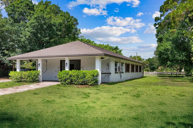 3442 C Rd, Loxahatchee Groves, FL 33470 - view of front facade with stucco siding, a carport, roof with shingles, and driveway