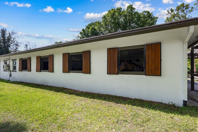 3442 C Rd, Loxahatchee Groves, FL 33470 - view of side of home with a yard and stucco siding