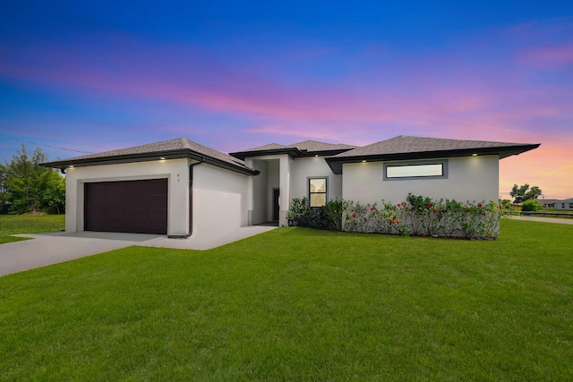 418 NE 31st Ter, Cape Coral, FL 33909 - prairie-style home featuring driveway, an attached garage, a front lawn, and stucco siding