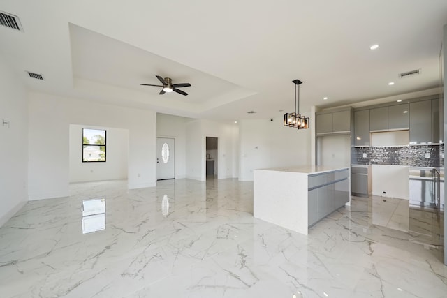 418 NE 31st Ter, Cape Coral, FL 33909 - kitchen featuring gray cabinets, modern cabinets, open floor plan, recessed lighting, and a raised ceiling