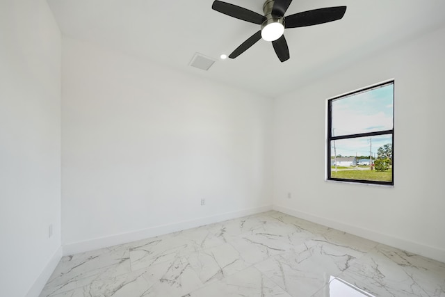 418 NE 31st Ter, Cape Coral, FL 33909 - spare room featuring baseboards, a ceiling fan, and light marble finish floors
