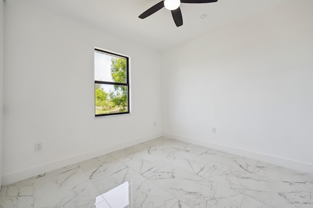 418 NE 31st Ter, Cape Coral, FL 33909 - unfurnished room featuring baseboards, a ceiling fan, and light marble finish floors