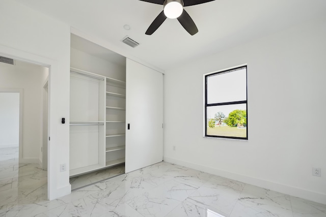418 NE 31st Ter, Cape Coral, FL 33909 - unfurnished bedroom featuring baseboards, marble finish floors, and a closet