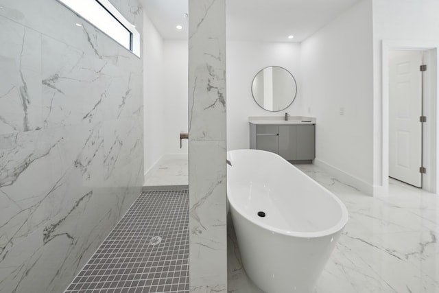 418 NE 31st Ter, Cape Coral, FL 33909 - bathroom featuring marble tiled floors, vanity, a freestanding tub, and recessed lighting