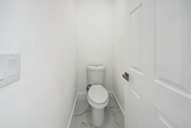 418 NE 31st Ter, Cape Coral, FL 33909 - bathroom featuring marble finish floors, baseboards, and toilet