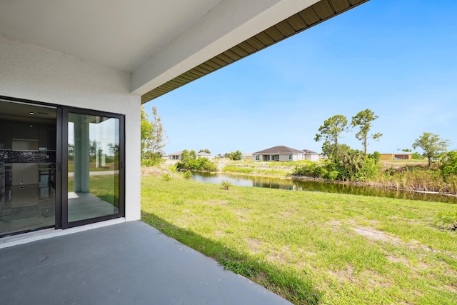 418 NE 31st Ter, Cape Coral, FL 33909 - view of grassy yard featuring a water view and a patio