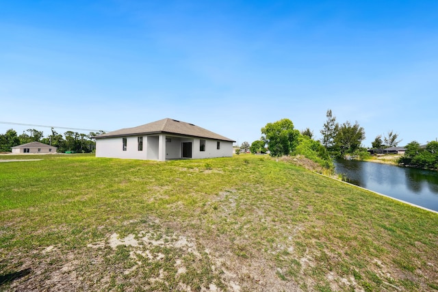 418 NE 31st Ter, Cape Coral, FL 33909 - view of grassy yard featuring a water view