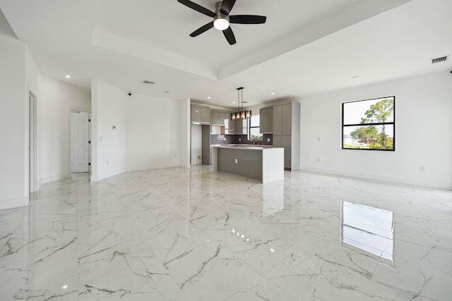418 NE 31st Ter, Cape Coral, FL 33909 - unfurnished living room featuring a chandelier, ceiling fan, recessed lighting, baseboards, and light marble finish flooring