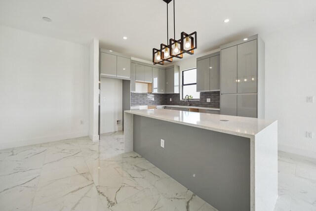 418 NE 31st Ter, Cape Coral, FL 33909 - kitchen with modern cabinets, light marble finish flooring, gray cabinetry, baseboards, and recessed lighting