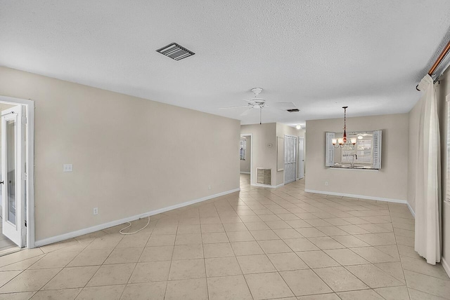 1801 Indian River Blvd Unit B8, Vero Beach, FL 32960 - spare room featuring a chandelier, ceiling fan, baseboards, a textured ceiling, and light tile patterned flooring