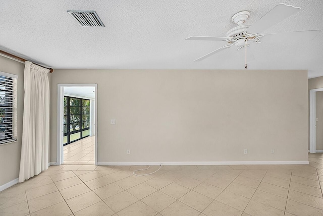 1801 Indian River Blvd Unit B8, Vero Beach, FL 32960 - unfurnished room with a ceiling fan, light tile patterned flooring, a textured ceiling, and baseboards