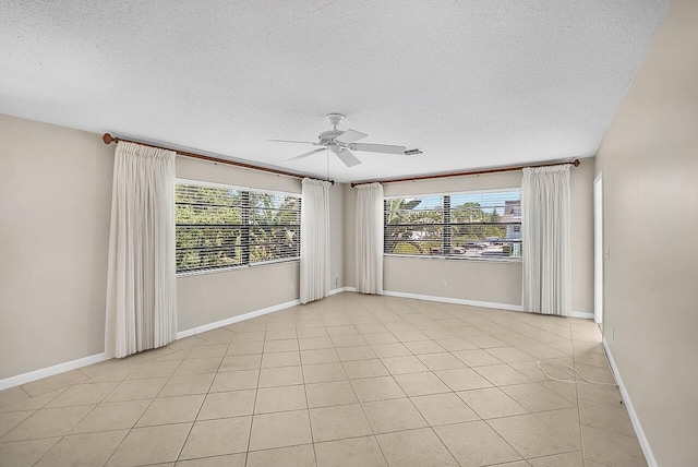 1801 Indian River Blvd Unit B8, Vero Beach, FL 32960 - spare room featuring ceiling fan, a textured ceiling, baseboards, and light tile patterned floors