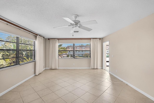 1801 Indian River Blvd Unit B8, Vero Beach, FL 32960 - spare room with a ceiling fan, a textured ceiling, light tile patterned flooring, and baseboards