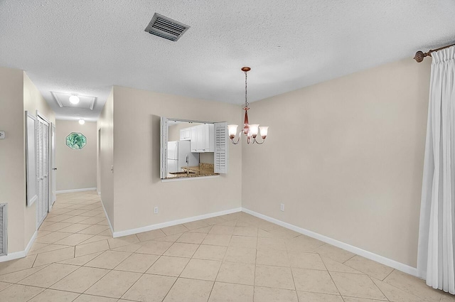 1801 Indian River Blvd Unit B8, Vero Beach, FL 32960 - empty room with a textured ceiling, light tile patterned flooring, a chandelier, a sink, and baseboards