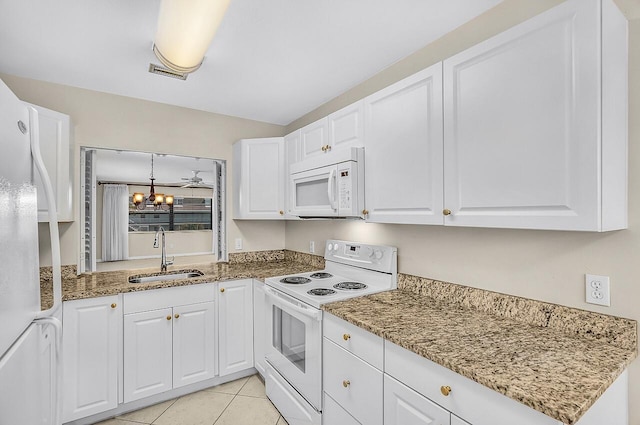 1801 Indian River Blvd Unit B8, Vero Beach, FL 32960 - kitchen featuring white appliances, a sink, white cabinetry, a chandelier, and light stone counters