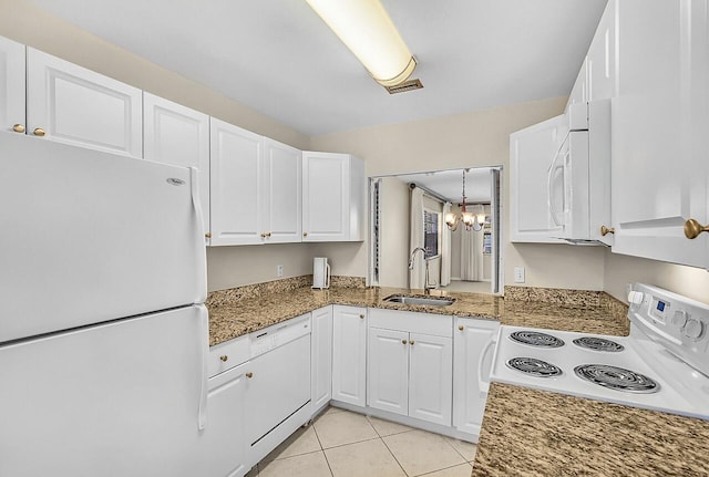 1801 Indian River Blvd Unit B8, Vero Beach, FL 32960 - kitchen featuring white appliances, a sink, white cabinets, and light stone countertops