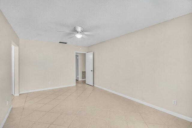 1801 Indian River Blvd Unit B8, Vero Beach, FL 32960 - spare room with ceiling fan, light tile patterned flooring, a textured ceiling, and baseboards