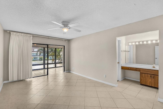 1801 Indian River Blvd Unit B8, Vero Beach, FL 32960 - spare room with a ceiling fan, baseboards, a textured ceiling, and light tile patterned floors