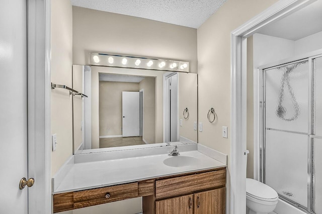 1801 Indian River Blvd Unit B8, Vero Beach, FL 32960 - bathroom with toilet, a shower stall, vanity, a textured ceiling, and tile patterned floors