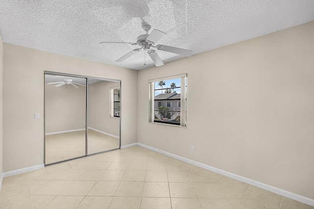 1801 Indian River Blvd Unit B8, Vero Beach, FL 32960 - unfurnished bedroom featuring a textured ceiling, a closet, a ceiling fan, and baseboards