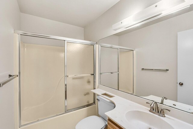 1801 Indian River Blvd Unit B8, Vero Beach, FL 32960 - full bathroom featuring vanity, enclosed tub / shower combo, and toilet