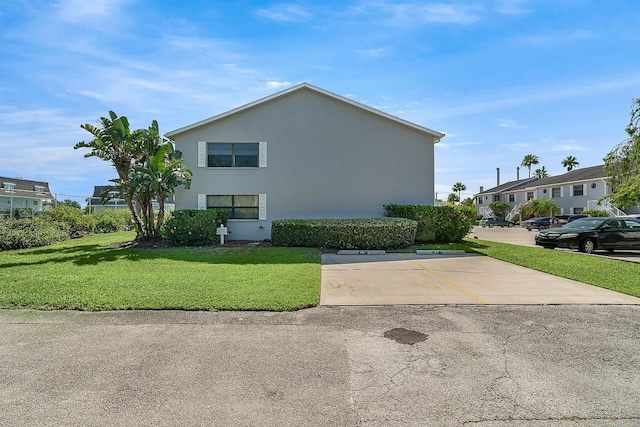 1801 Indian River Blvd Unit B8, Vero Beach, FL 32960 - view of home's exterior with a yard, uncovered parking, and stucco siding