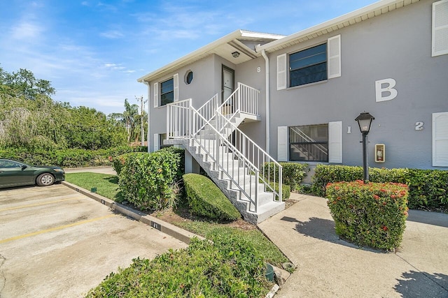 1801 Indian River Blvd Unit B8, Vero Beach, FL 32960 - view of building exterior featuring stairs and uncovered parking