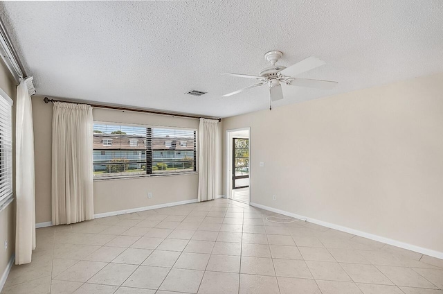 1801 Indian River Blvd Unit B8, Vero Beach, FL 32960 - unfurnished room featuring ceiling fan, a textured ceiling, baseboards, and light tile patterned floors