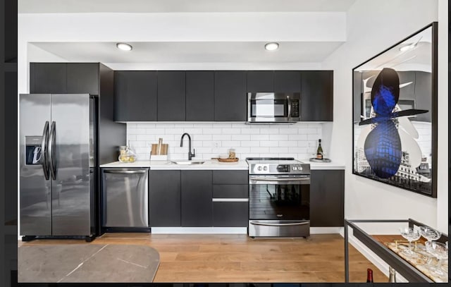 398 NE 5th St Unit 2503, Miami, FL 33132 - kitchen with appliances with stainless steel finishes, a sink, dark cabinetry, and light countertops