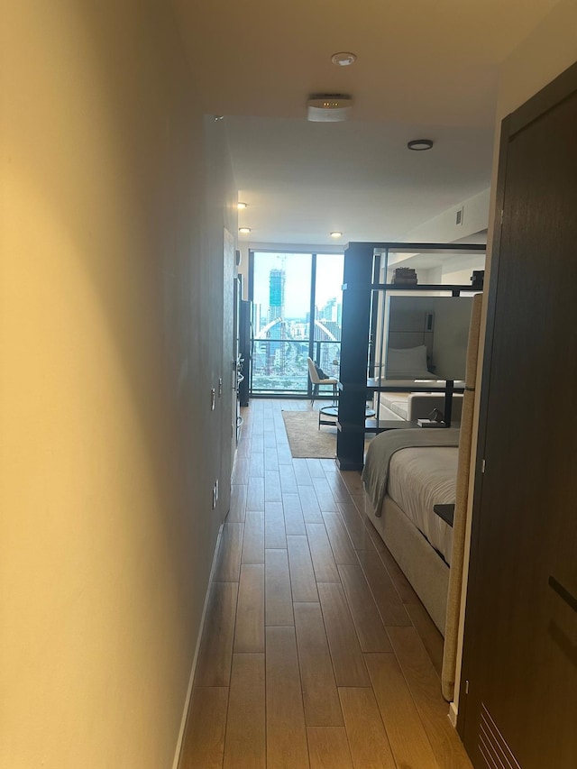 398 NE 5th St Unit 2503, Miami, FL 33132 - hallway featuring floor to ceiling windows, wood finished floors, and baseboards
