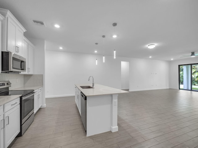 3181 Streng Ln, Royal Palm Beach, FL 33411 - kitchen featuring stainless steel appliances, a sink, open floor plan, decorative backsplash, and recessed lighting