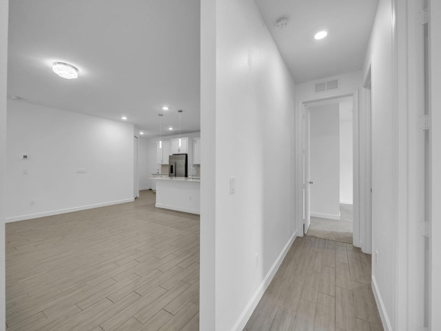 3181 Streng Ln, Royal Palm Beach, FL 33411 - hallway featuring light wood-style flooring, recessed lighting, and baseboards