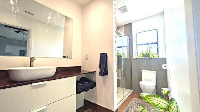 4344 Carambola Cir Unit F707, Coconut Creek, FL 33066 - bathroom with wood finished floors, vanity, toilet, and a shower stall