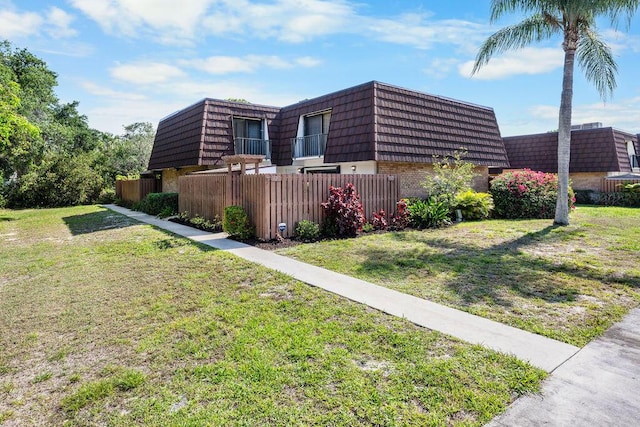 5642 SE Riverboat Dr Unit A5-120, Stuart, FL 34997 - view of side of home featuring mansard roof and brick siding