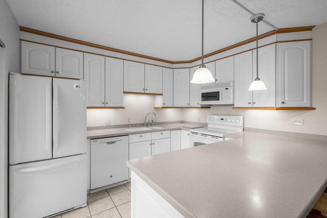 5642 SE Riverboat Dr Unit A5-120, Stuart, FL 34997 - kitchen featuring white appliances, a sink, a peninsula, pendant lighting, and a textured ceiling