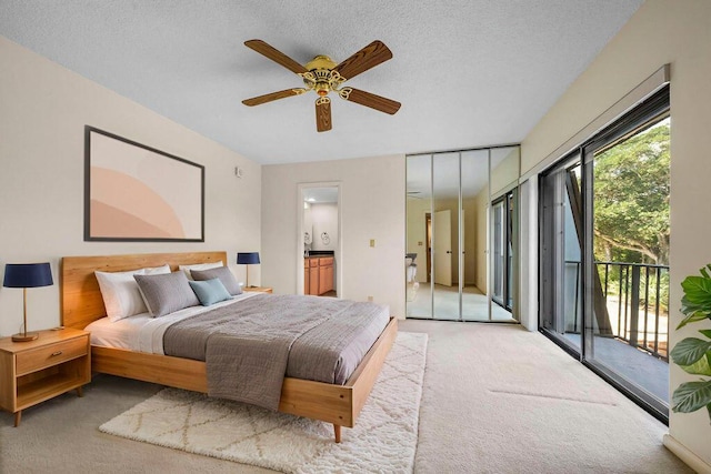 5642 SE Riverboat Dr Unit A5-120, Stuart, FL 34997 - bedroom with light colored carpet, access to exterior, ensuite bathroom, a ceiling fan, and a textured ceiling
