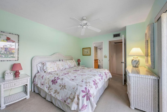 5642 SE Riverboat Dr Unit A5-120, Stuart, FL 34997 - bedroom with light carpet, ensuite bathroom, and a ceiling fan