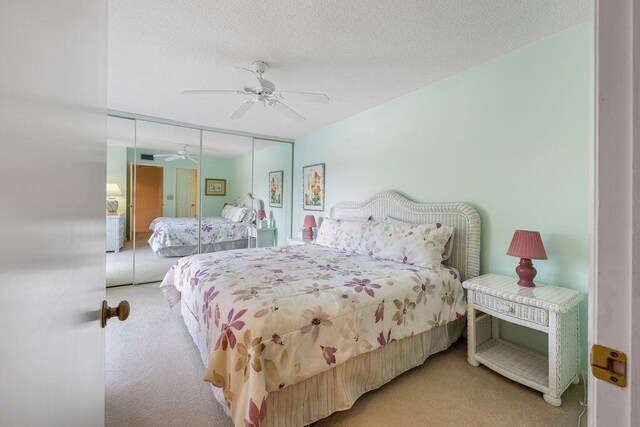5642 SE Riverboat Dr Unit A5-120, Stuart, FL 34997 - carpeted bedroom featuring a closet, ceiling fan, and a textured ceiling