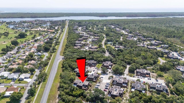 5642 SE Riverboat Dr Unit A5-120, Stuart, FL 34997 - aerial view of property's location featuring a nearby body of water, nearby suburban area, and a heavily wooded area