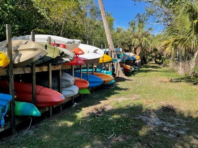5642 SE Riverboat Dr Unit A5-120, Stuart, FL 34997 - view of playground featuring a yard and view of wooded area