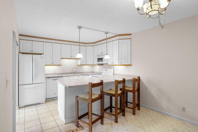 5642 SE Riverboat Dr Unit A5-120, Stuart, FL 34997 - kitchen with white appliances, a peninsula, light countertops, a sink, and a textured ceiling