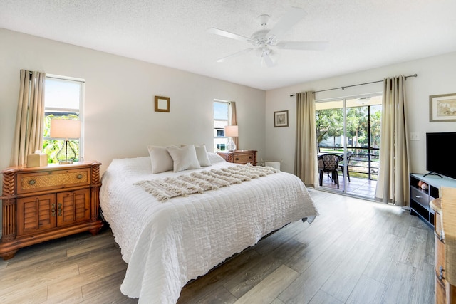 5890 Sugar Palm Ct Unit E, Delray Beach, FL 33484 - bedroom featuring access to outside, multiple windows, wood finished floors, and ceiling fan