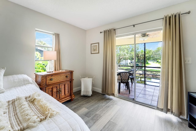 5890 Sugar Palm Ct Unit E, Delray Beach, FL 33484 - bedroom with access to exterior, light wood-style flooring, and baseboards
