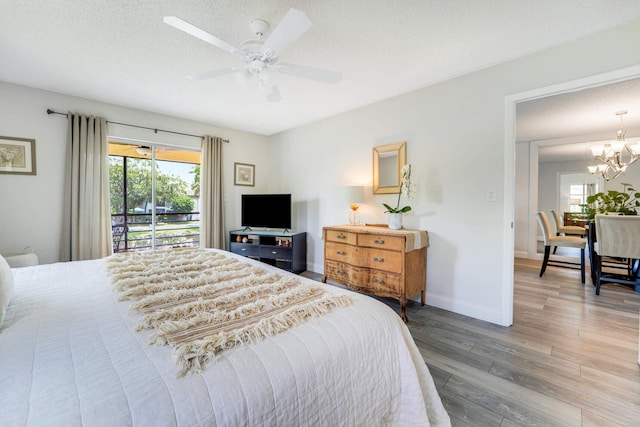 5890 Sugar Palm Ct Unit E, Delray Beach, FL 33484 - bedroom with multiple windows, wood finished floors, access to outside, and a chandelier