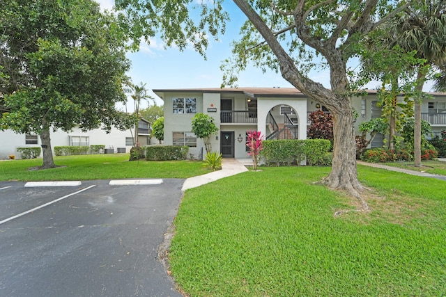 5890 Sugar Palm Ct Unit E, Delray Beach, FL 33484 - multi unit property featuring uncovered parking, a front lawn, stucco siding, and a balcony