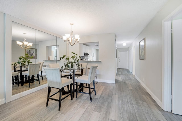 5890 Sugar Palm Ct Unit E, Delray Beach, FL 33484 - dining room with a chandelier, light wood finished floors, and baseboards