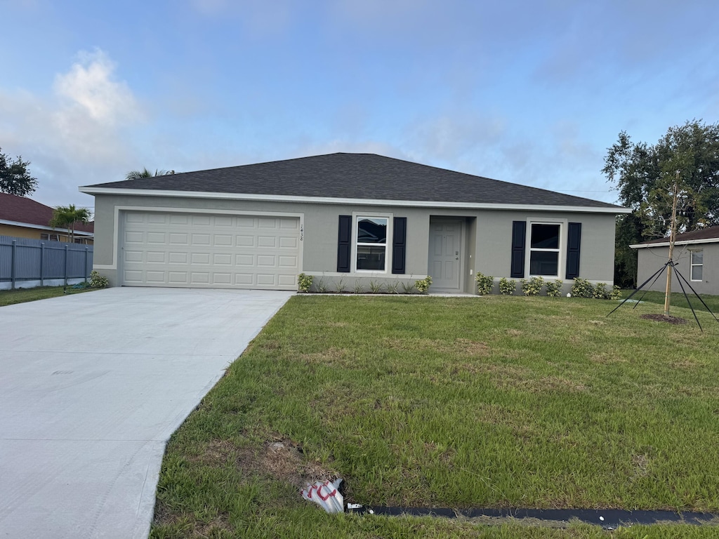 1438 SW Goodman Ave, Port Saint Lucie, FL 34953 - ranch-style home featuring driveway, an attached garage, stucco siding, and roof with shingles