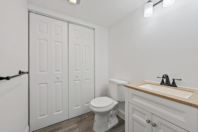 1021 10th Ct Unit 1021, Palm Beach Gardens, FL 33410 - bathroom with a closet, vanity, toilet, and wood finished floors