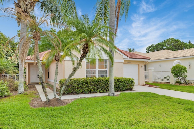2045 SW Olympic Club Ter, Palm City, FL 34990 - view of front of home featuring a tiled roof, a garage, driveway, and stucco siding