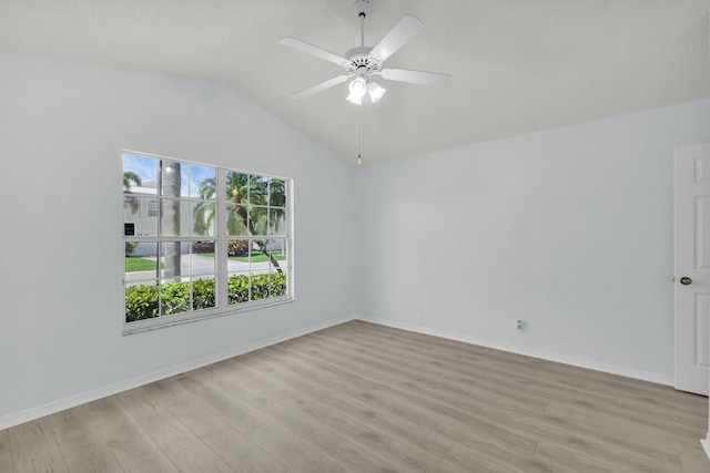 2045 SW Olympic Club Ter, Palm City, FL 34990 - empty room with light wood-style flooring, a ceiling fan, vaulted ceiling, and baseboards